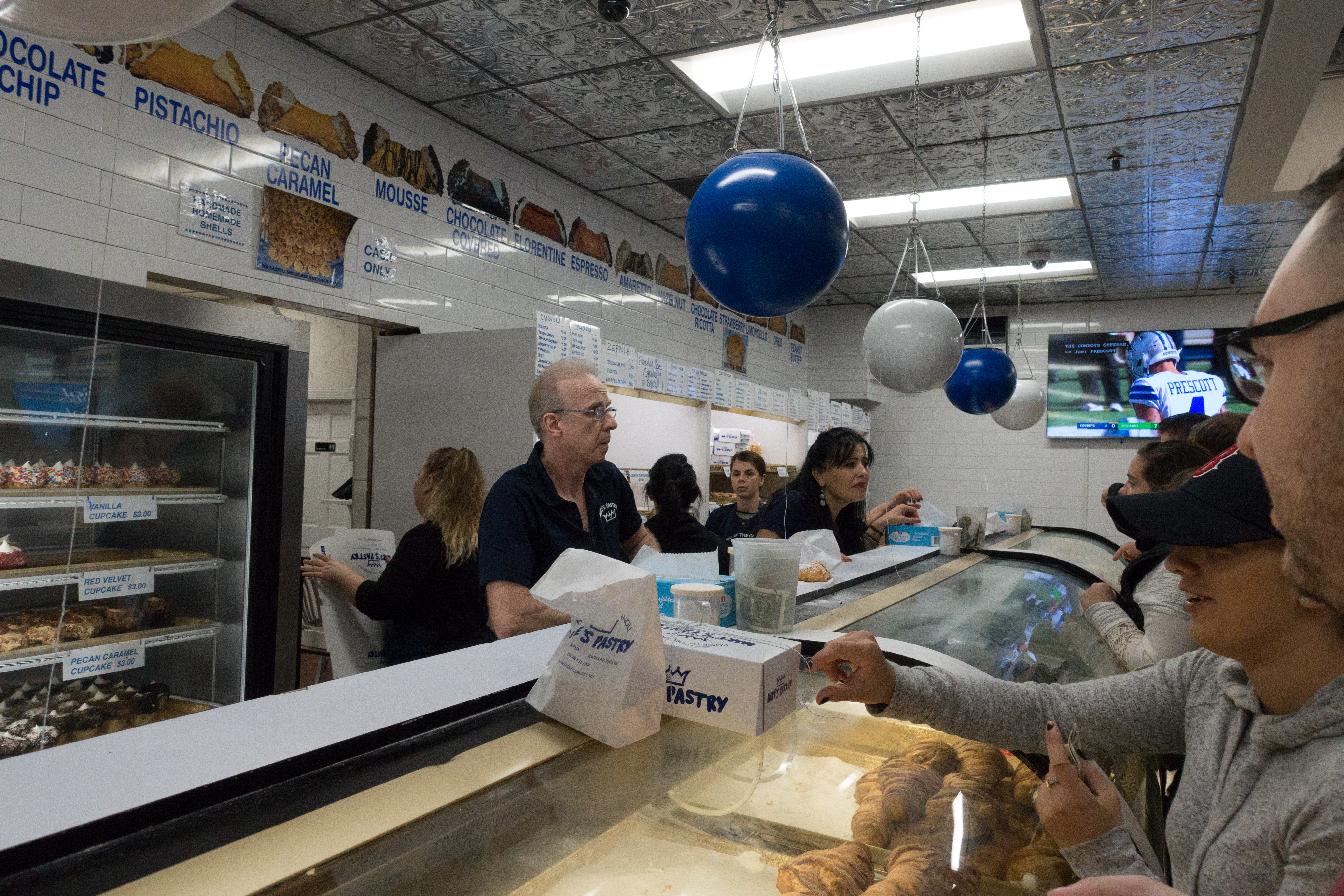 A look inside the crazy busy pastry shop near Paul Revere's House along the Freedom Trail.  Mike's pastries is a great place to grab canolis in Boston, Massacusetts 