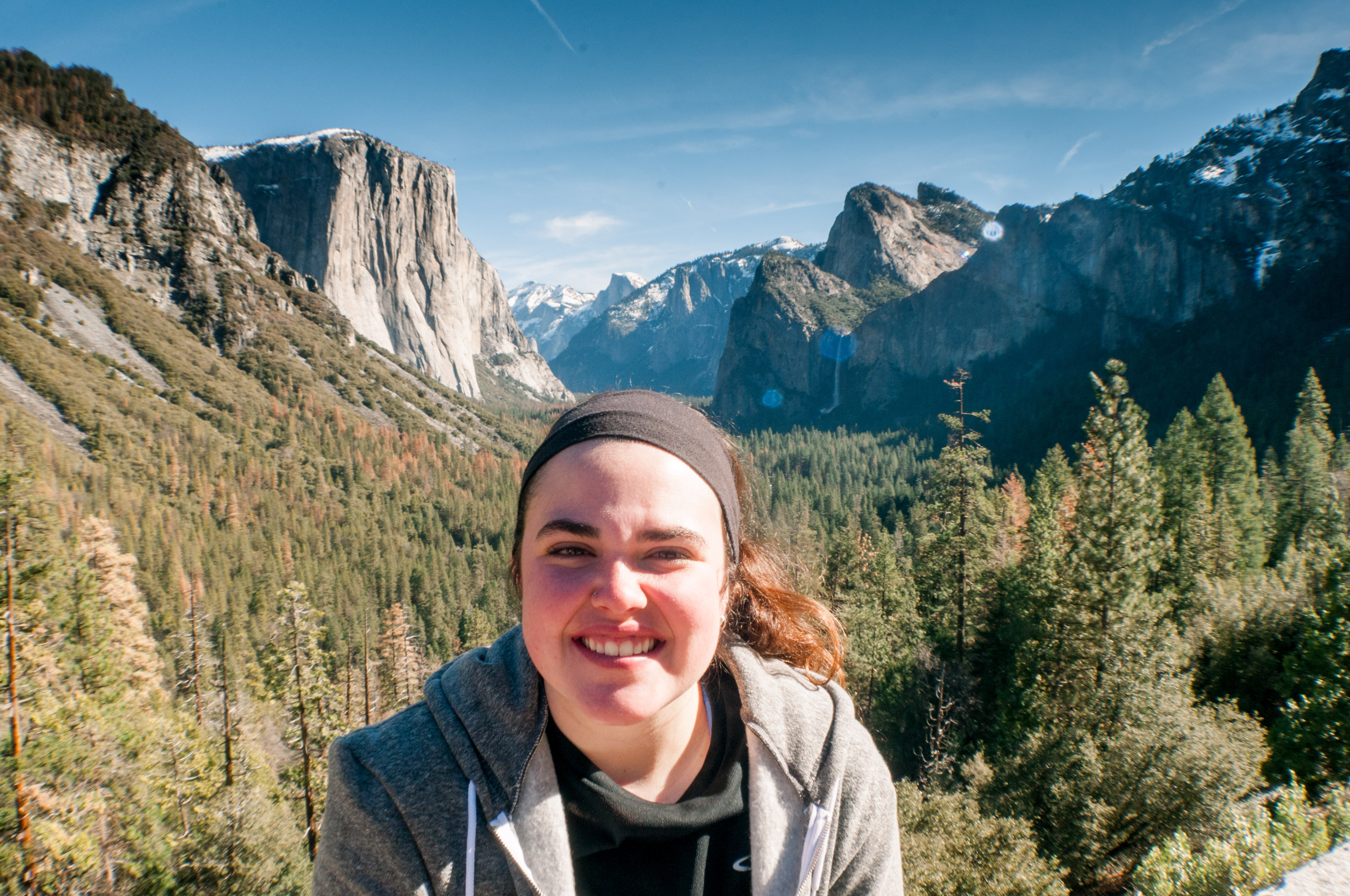 Kelly Blick on a sunny day in Yosemite Valley in California in the United States.  Posing in front of Yosemite Valley as seen from Tunnel View Look Out Point.  