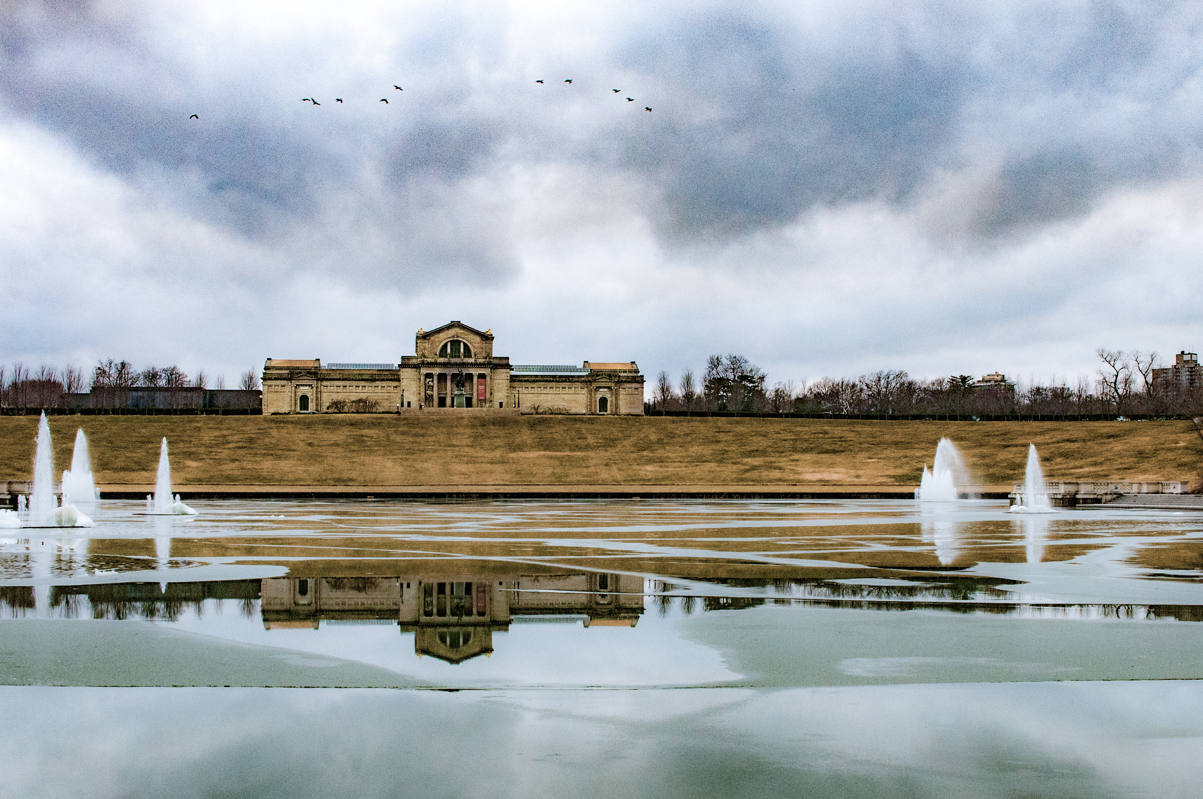 Art Hill in Forest Park in St. Louis Missouri on a frigid winter day.  The Art Museum overlooks the Grand Basin which is completely covered in ice. 